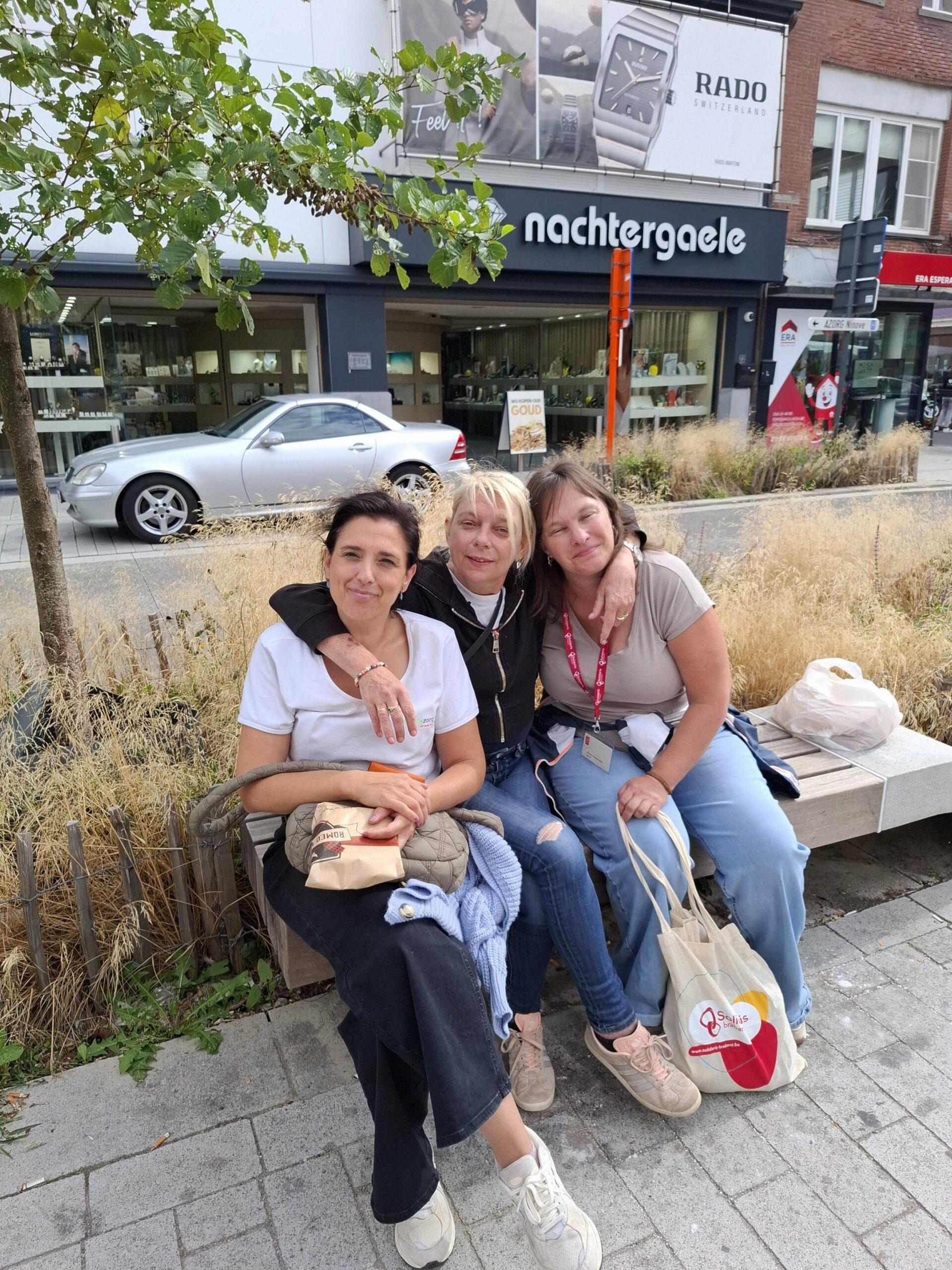 Drie vrouwen buiten op een bankje: Cindy, cliënte bij Familiezorg, Carolien, verzorgende bij Familiezorg en Sabine, bezoeker van Solidaris
